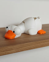 Close-up of mini flexi goose figure with large movable googly eyes on white background