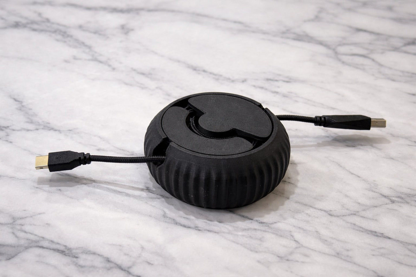 Close-up of cable reel mechanism showing textured surface details from 3D printing process