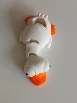 Detail of the movable googly eyes on the mini flexi goose figure, showing rotation positions