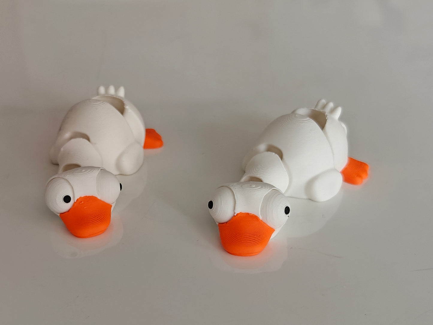 Close-up of mini flexi goose figure with large movable googly eyes on white background