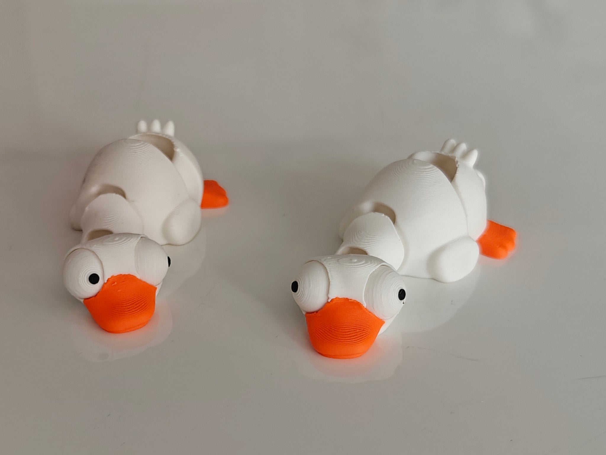 Close-up of mini flexi goose figure with large movable googly eyes on white background
