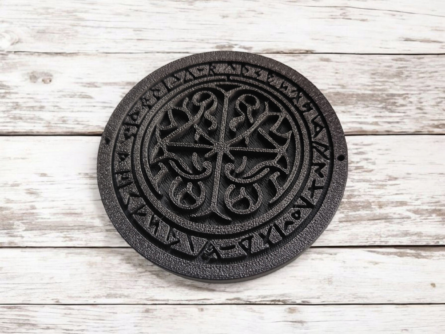 Detail view of the textured surface and rune symbols on the square runestone coaster