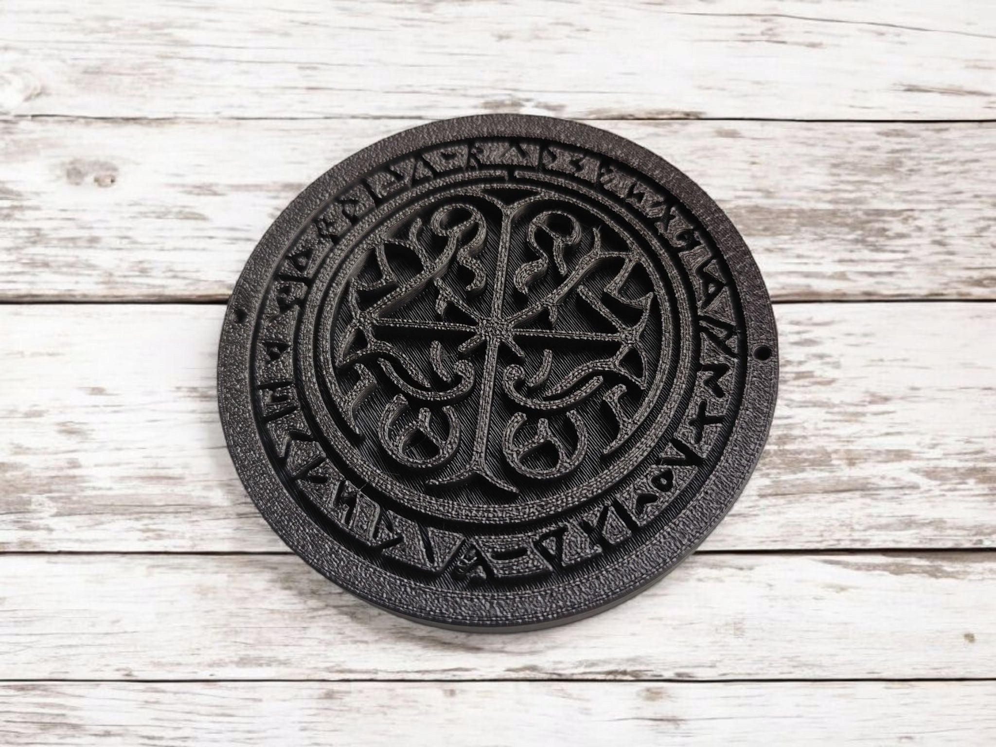 Detail view of the textured surface and rune symbols on the square runestone coaster