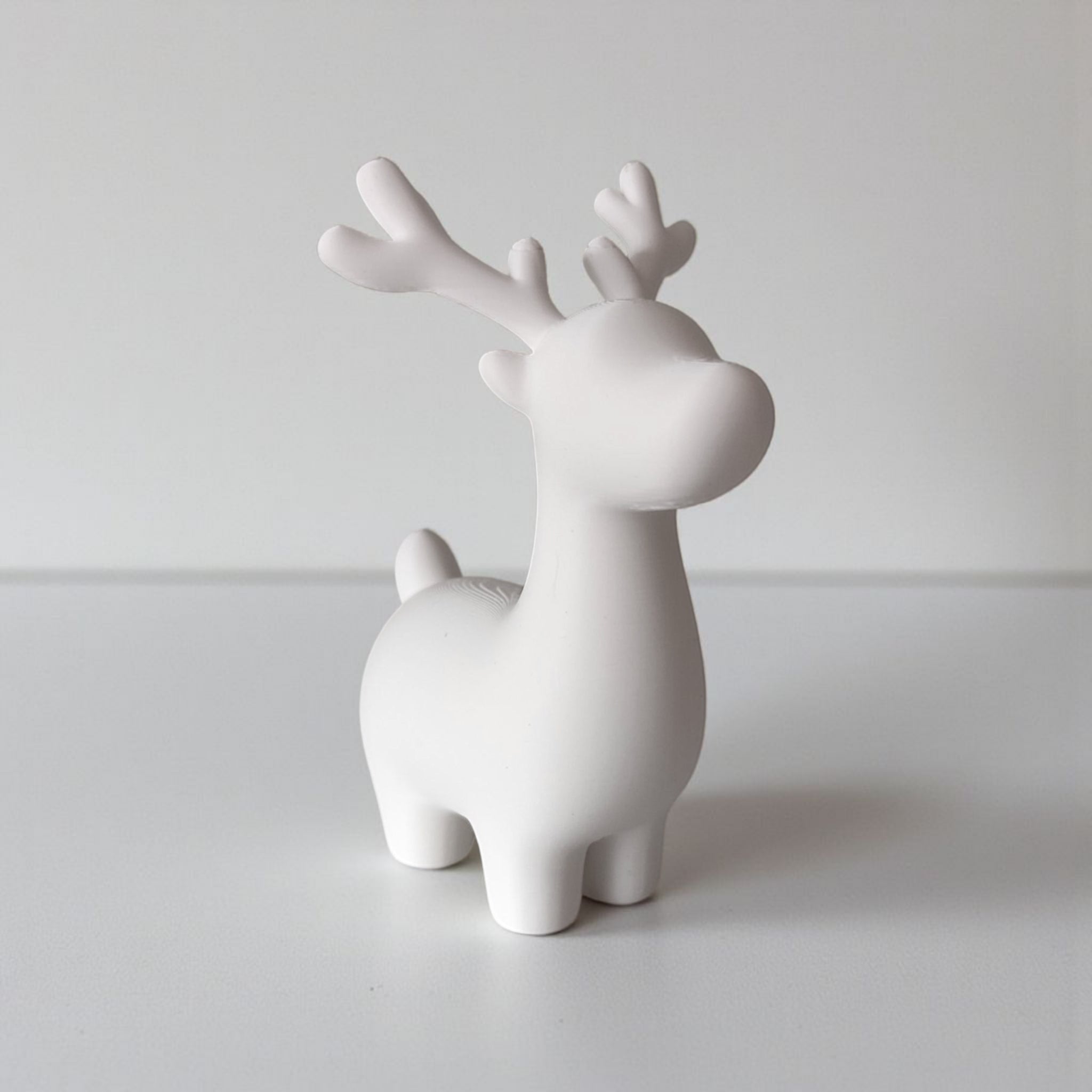 Close-up of minimalist Christmas reindeer decoration showing clean lines