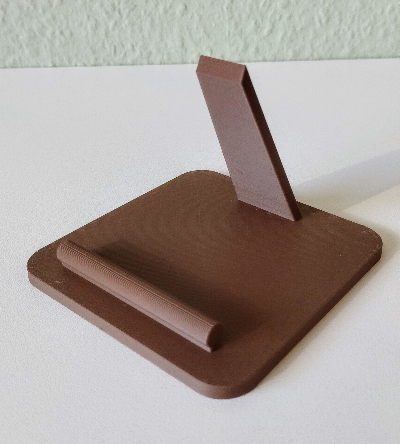 Detail view of the clean-lined support structure of the minimalist phone stand