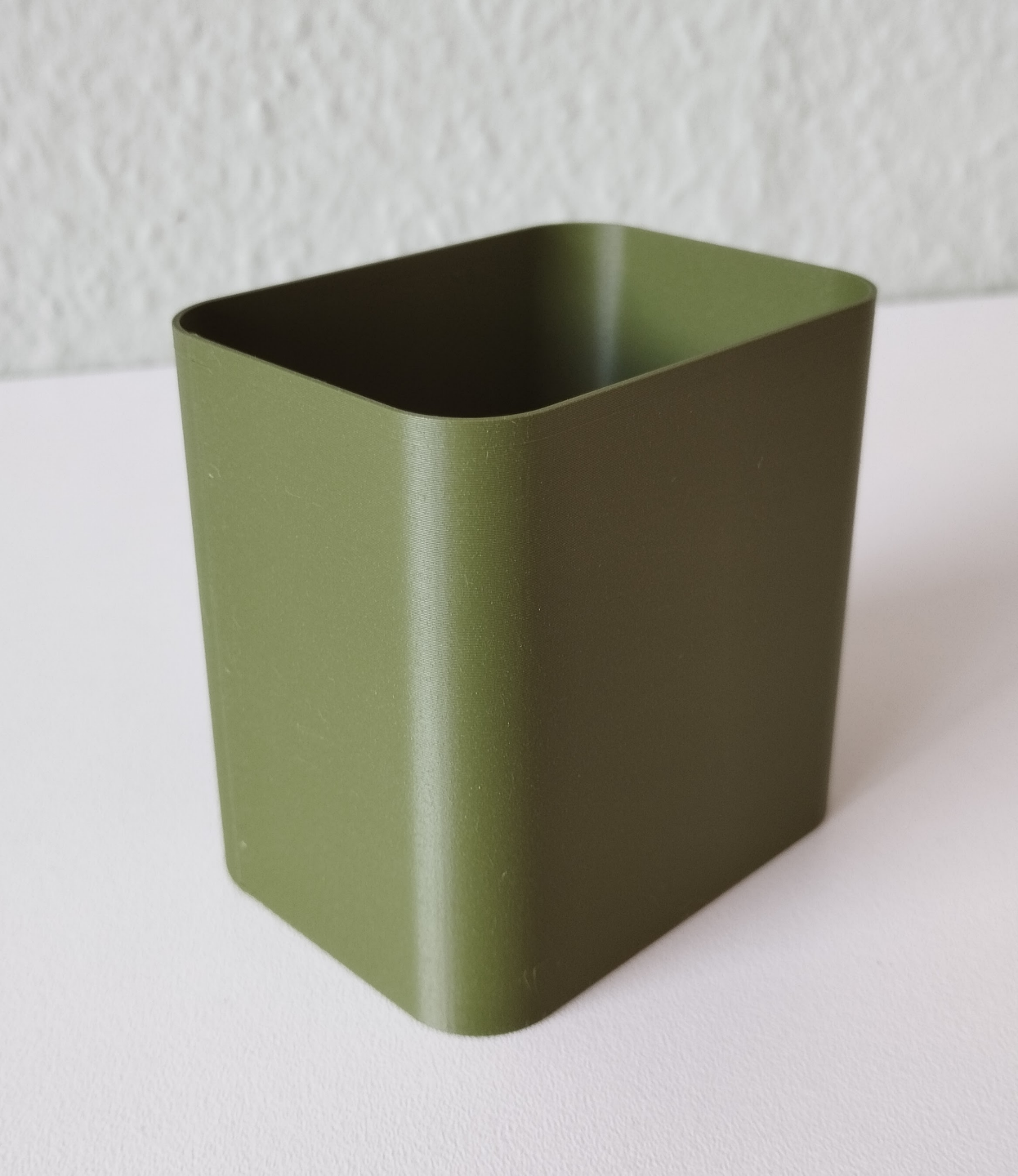 Detail of minimalist pencil holder showing smooth surface and refined edges