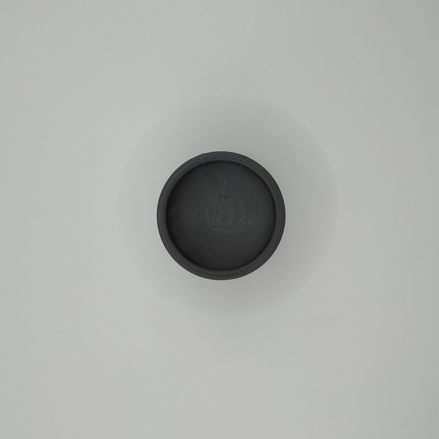 Close-up of a matte white minimalist egg cup showing clean cone form