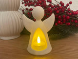 Englefigur med LED-fyrfadslys, der lyser indefra