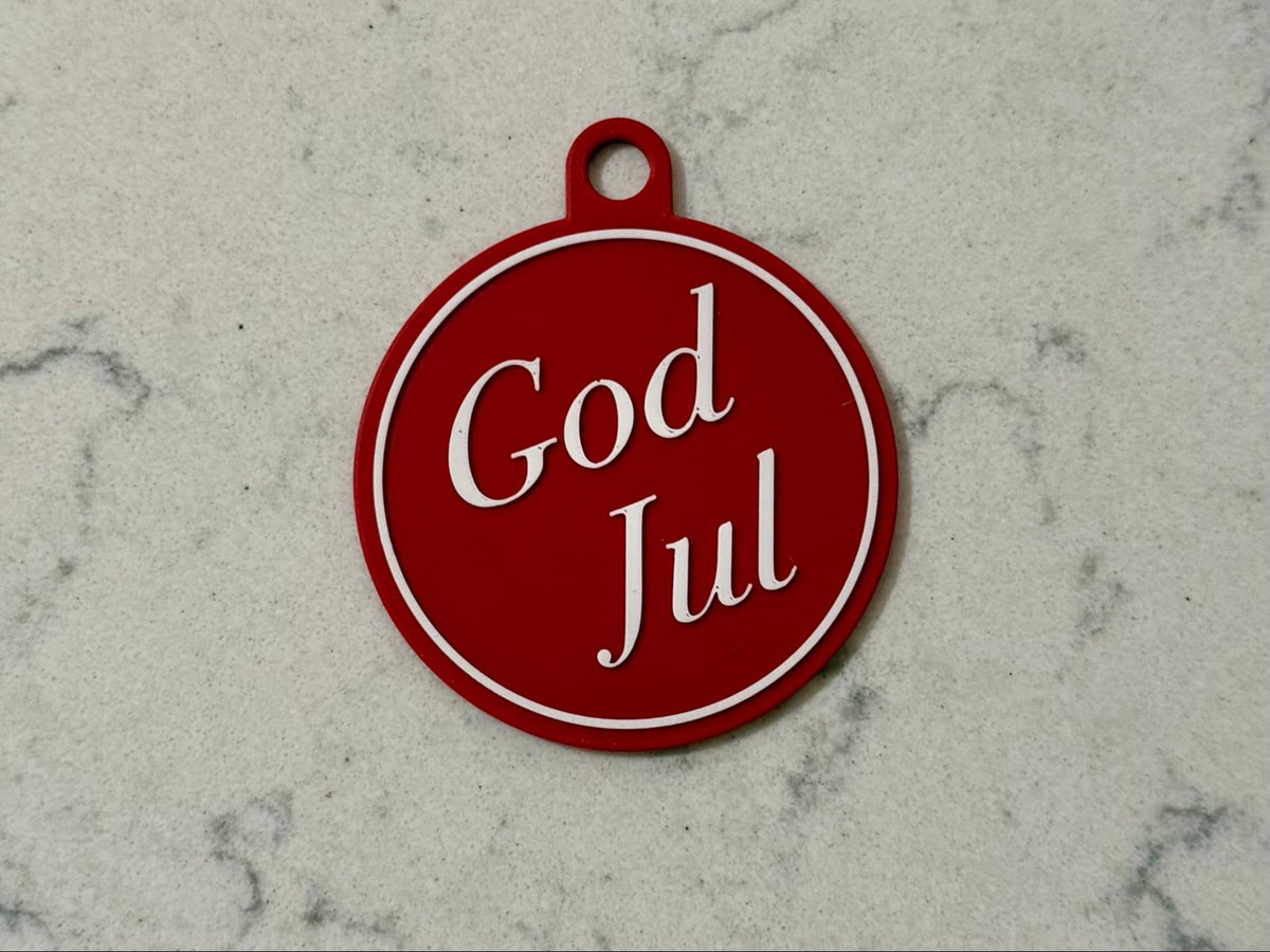 Elegant juletræspynt med teksten God Jul
