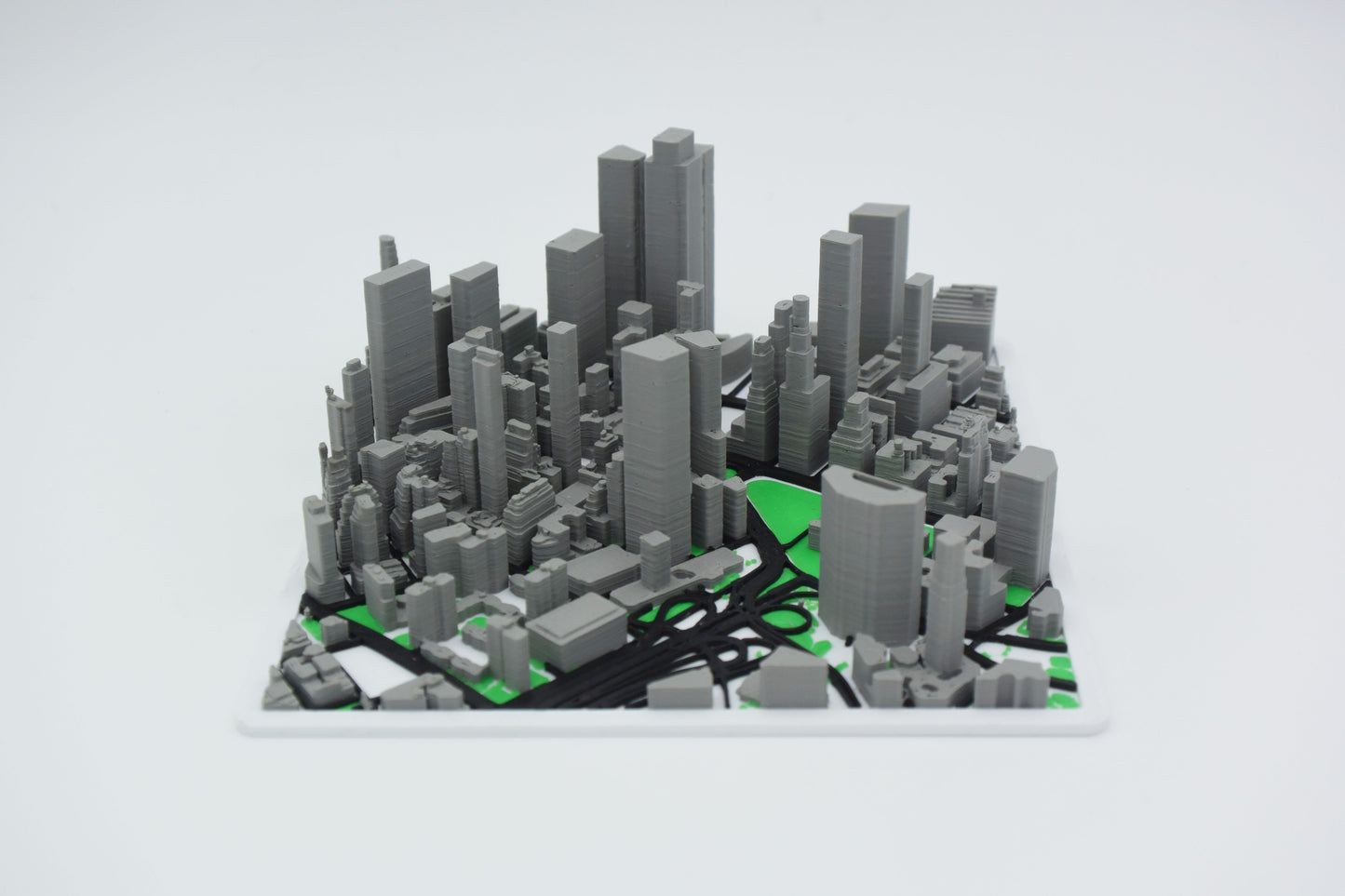 Detail shot of a personalized 3D map surface showing elevation ridges and street-level texture