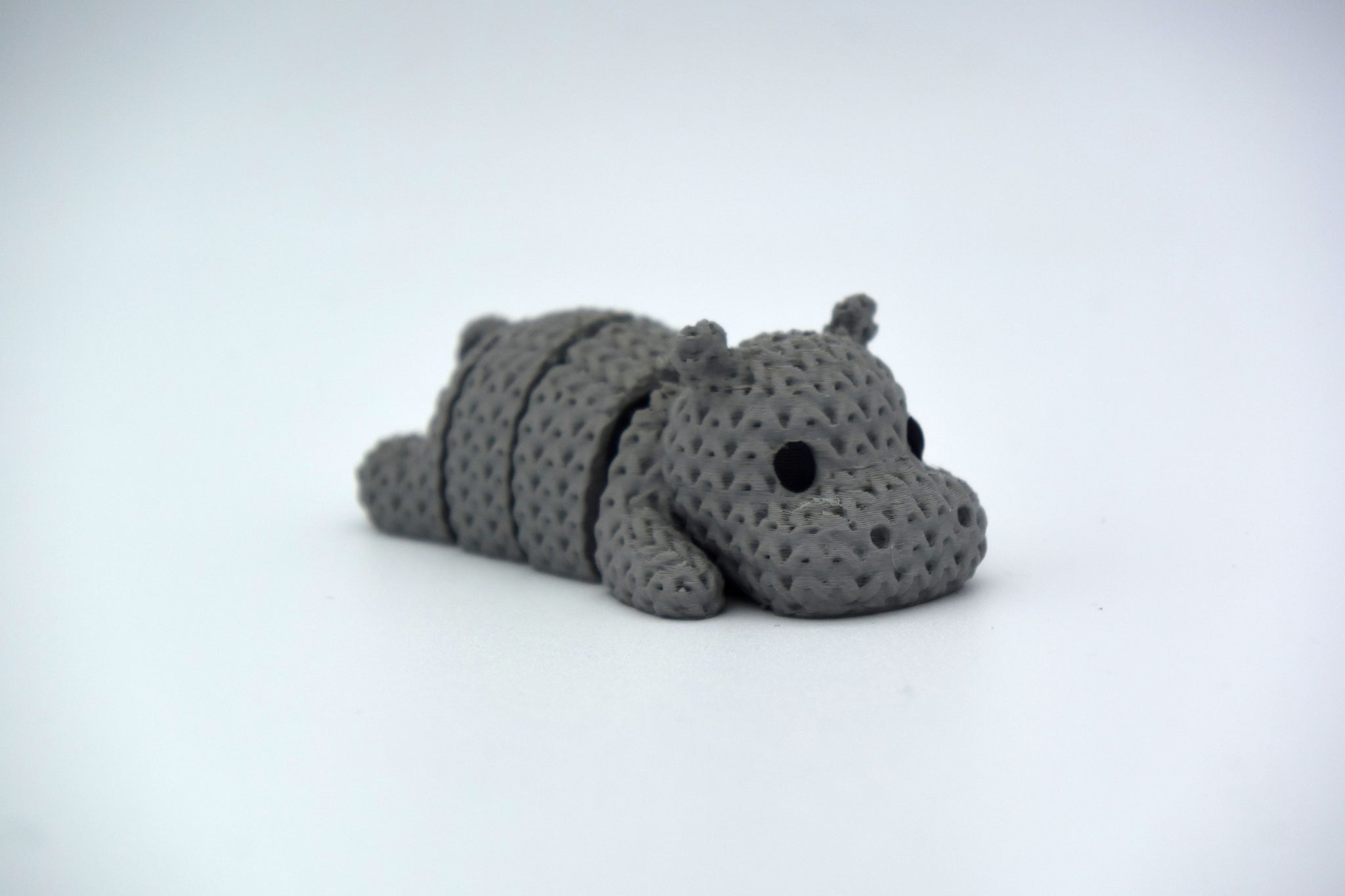 Detail shot of the knitted hippo's segmented body showing the soft woven texture and flexible joints