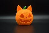 Crochet cat pumpkin glowing softly on a wooden shelf with autumn leaves and an LED tea light inside